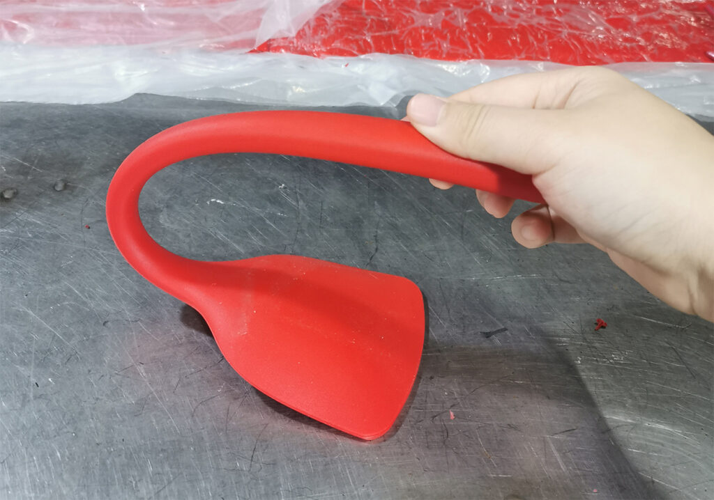hand bending a wok turner
